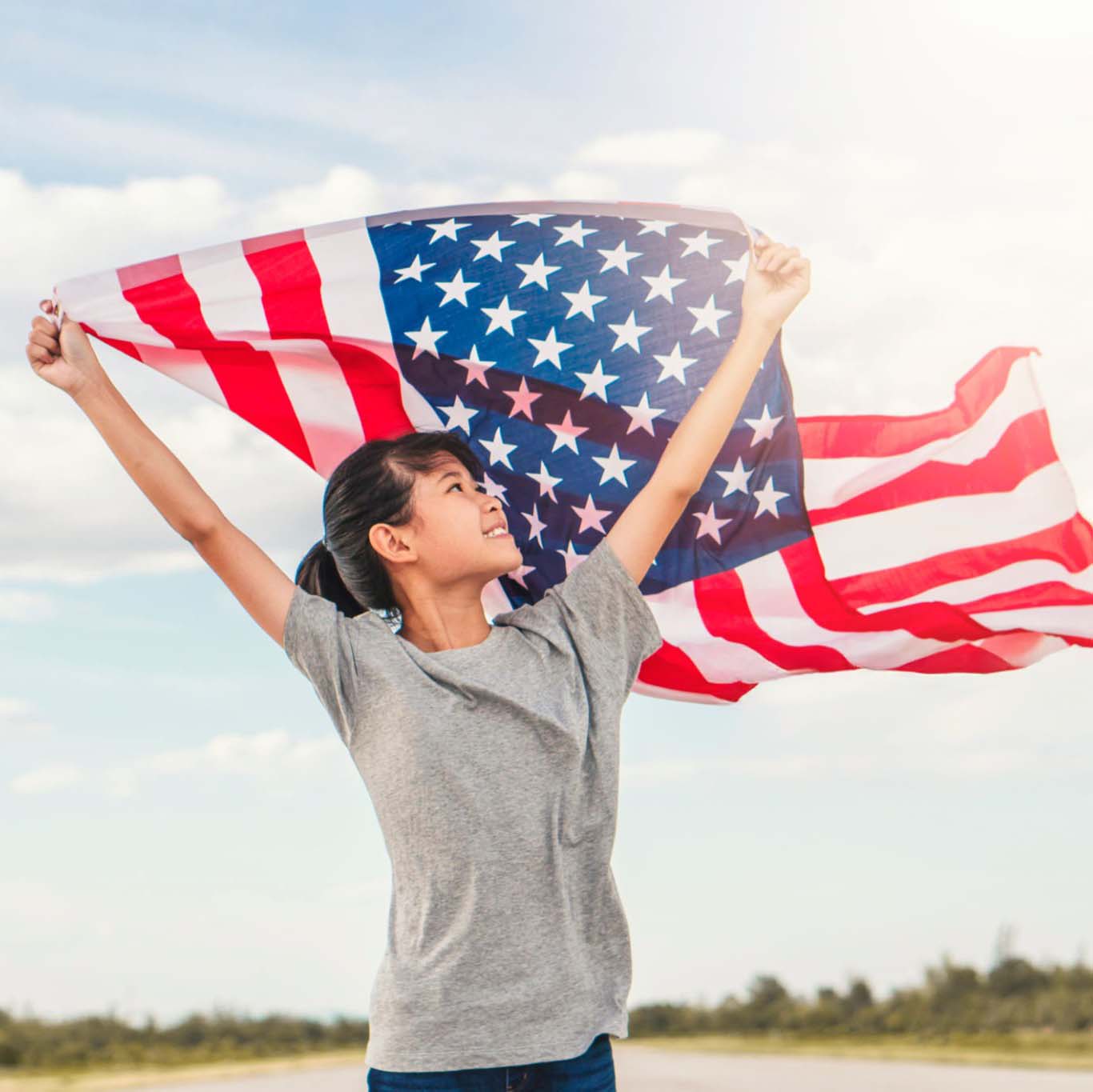 Happy asian little girl with American flag USA celebrate 4th of July